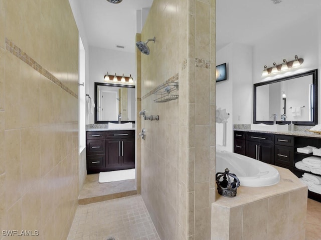 bathroom with a garden tub, a sink, two vanities, visible vents, and walk in shower