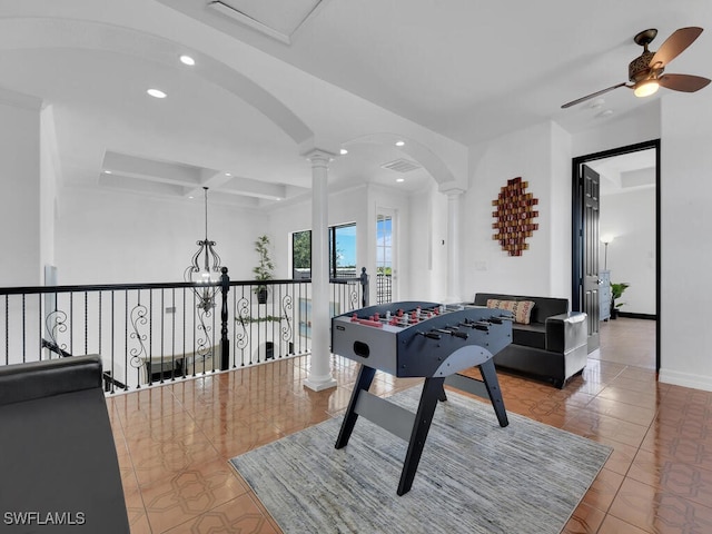 playroom with arched walkways, coffered ceiling, decorative columns, and recessed lighting