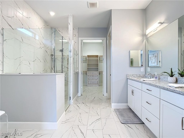 bathroom featuring walk in shower and vanity