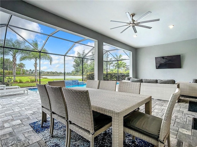 view of patio / terrace featuring ceiling fan, a lanai, and outdoor lounge area