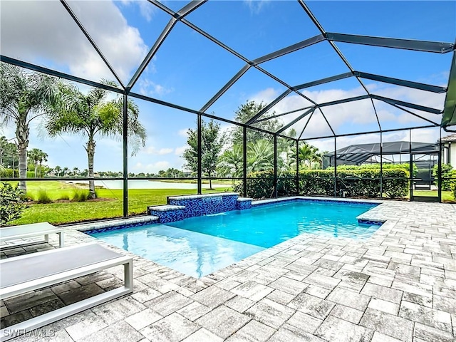 view of pool with glass enclosure, pool water feature, a water view, and a patio