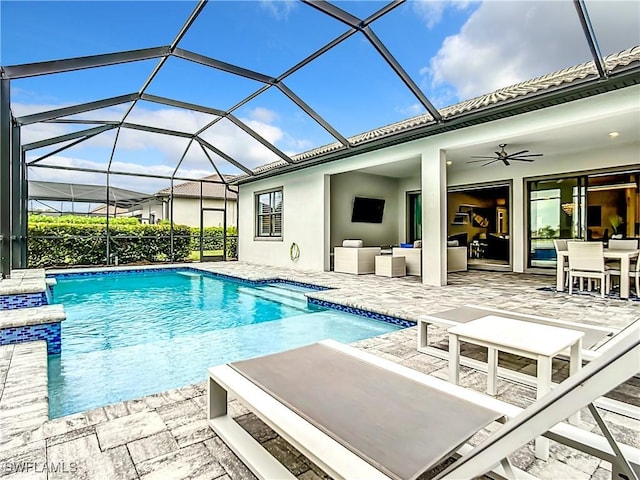 view of pool featuring ceiling fan, a lanai, an outdoor living space, and a patio