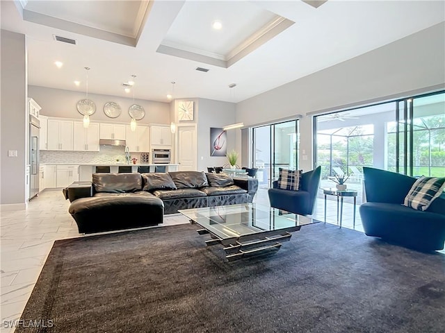 living room featuring coffered ceiling, beam ceiling, a towering ceiling, and crown molding