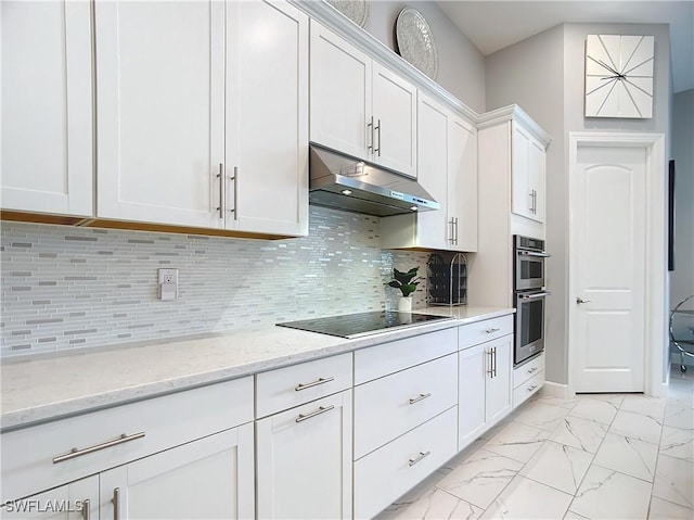 kitchen with backsplash, white cabinets, light stone countertops, black electric cooktop, and stainless steel double oven