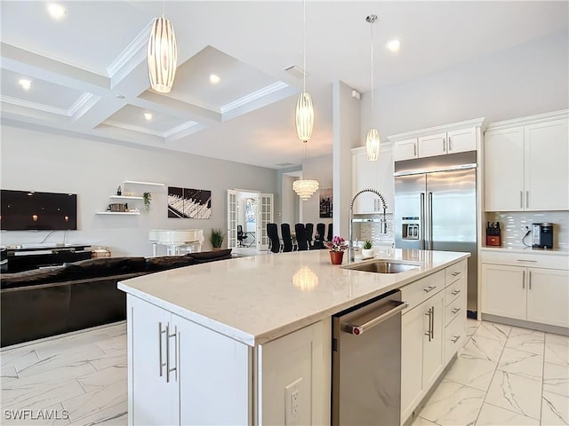 kitchen with appliances with stainless steel finishes, an island with sink, sink, hanging light fixtures, and coffered ceiling