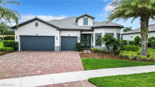 view of front of home with french doors and a garage