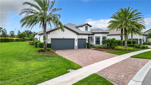 view of front of home with a front yard and a garage