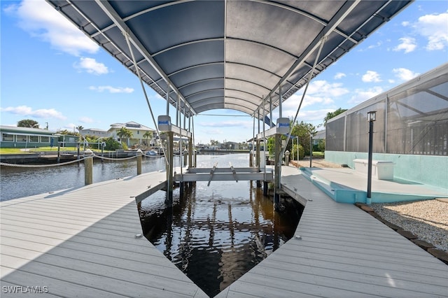 view of dock featuring a water view and a lanai