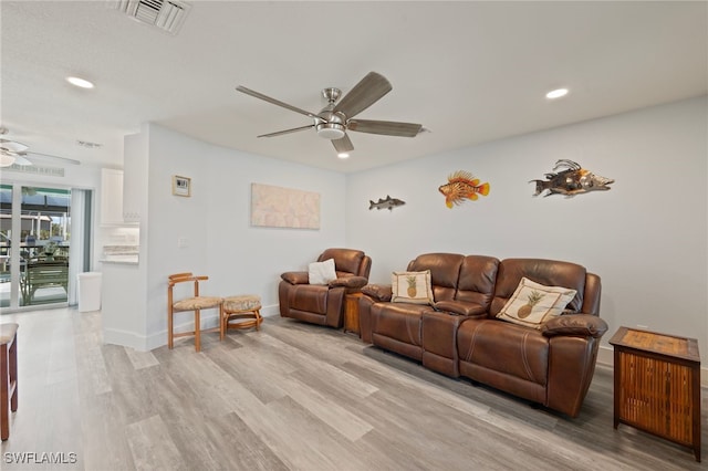 living room with ceiling fan and light wood-type flooring