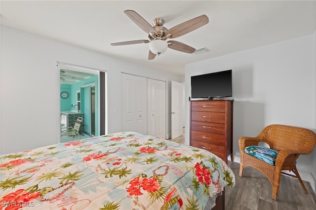 bedroom featuring ceiling fan, a closet, and hardwood / wood-style floors