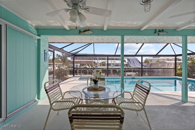 view of pool with a patio, ceiling fan, and a lanai