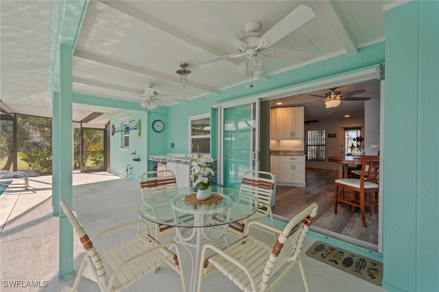 interior space with hardwood / wood-style floors, beam ceiling, ceiling fan, and sink