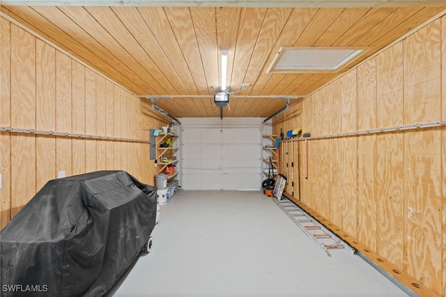 garage with wooden walls, wood ceiling, and a garage door opener