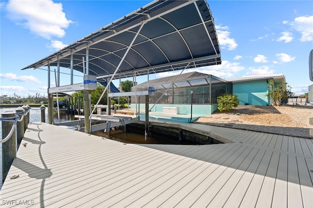 dock area with glass enclosure and a water view