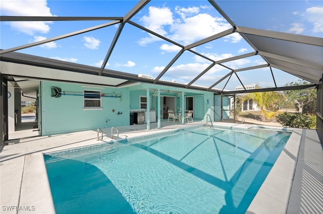 view of swimming pool featuring ceiling fan, a patio area, and glass enclosure