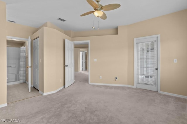 unfurnished bedroom with ensuite bath, ceiling fan, and light colored carpet