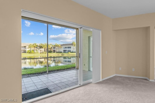 doorway with a water view and light colored carpet