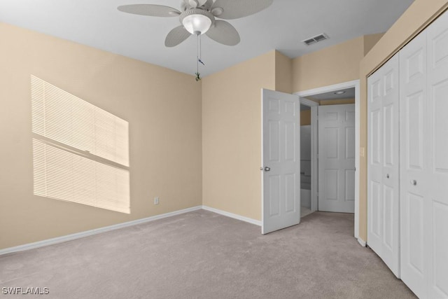 unfurnished bedroom with light carpet, a closet, and ceiling fan