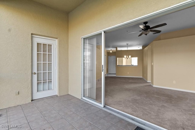 exterior space with ceiling fan with notable chandelier