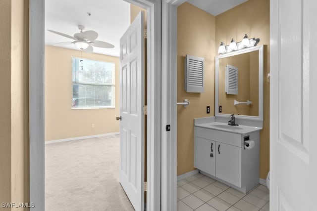 bathroom with ceiling fan, tile patterned flooring, and vanity