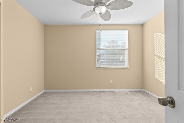 unfurnished room featuring ceiling fan and light colored carpet