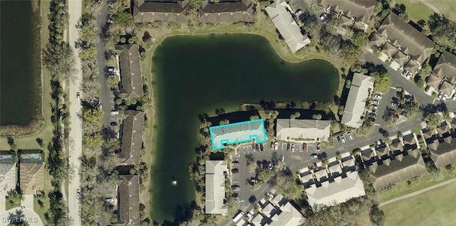 birds eye view of property with a water view