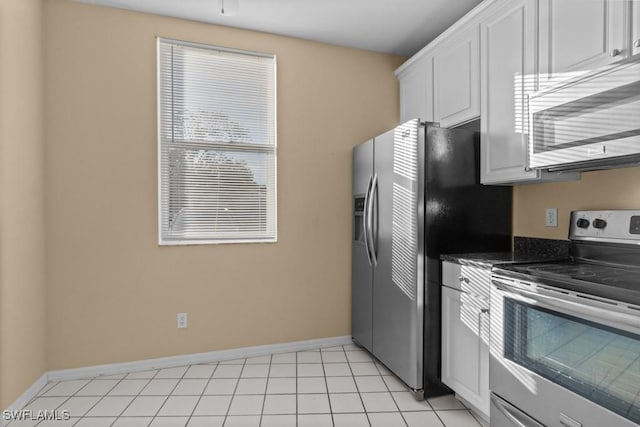 kitchen with white cabinets, light tile patterned floors, and stainless steel appliances