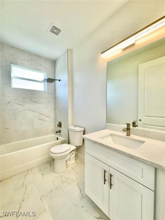 full bathroom featuring vanity, tiled shower / bath combo, and toilet