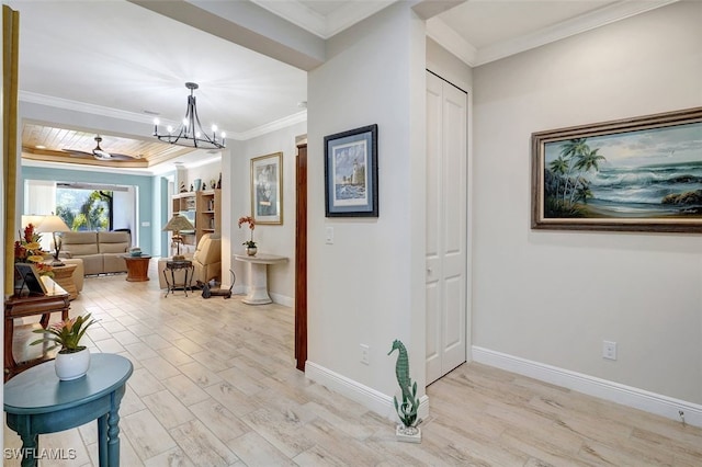 hall featuring ornamental molding, a chandelier, and light hardwood / wood-style floors