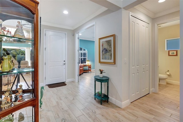 corridor with crown molding and light wood-type flooring