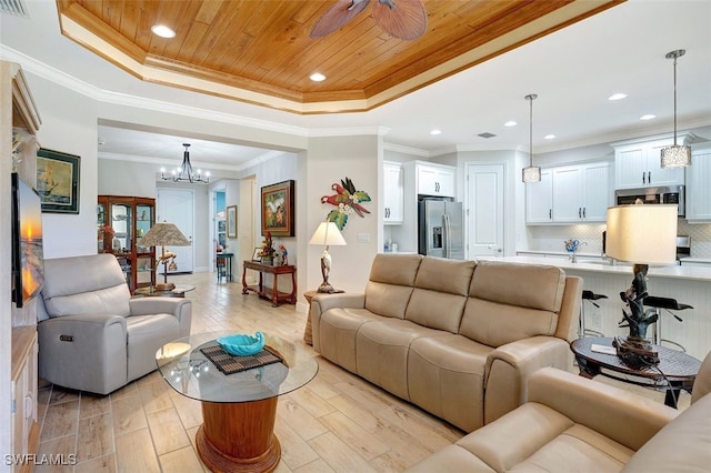 living room featuring wooden ceiling, light wood-type flooring, and a tray ceiling