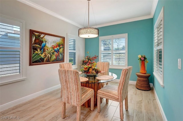 dining room featuring crown molding and light hardwood / wood-style floors