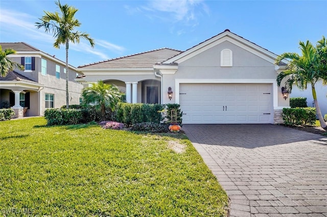 view of front of property with a garage and a front yard