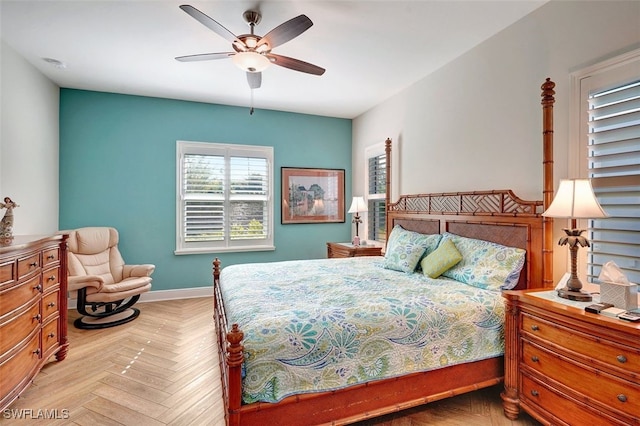 bedroom with ceiling fan and light parquet floors