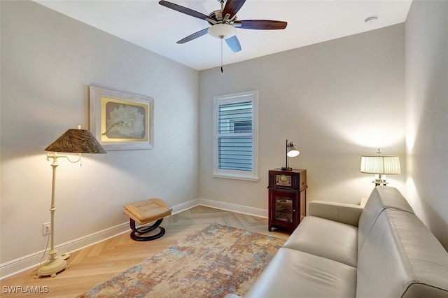 living area featuring parquet flooring and ceiling fan