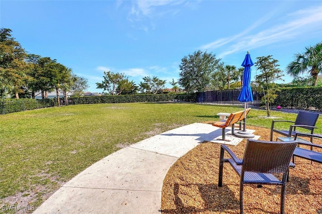 surrounding community with a yard and a patio area