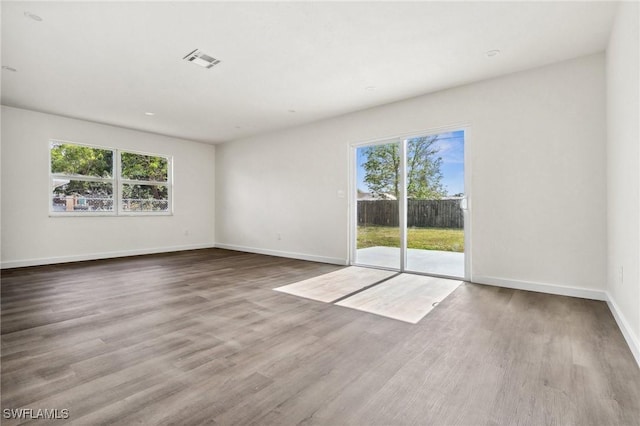 spare room with hardwood / wood-style floors