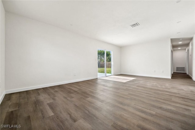 unfurnished room featuring dark hardwood / wood-style flooring