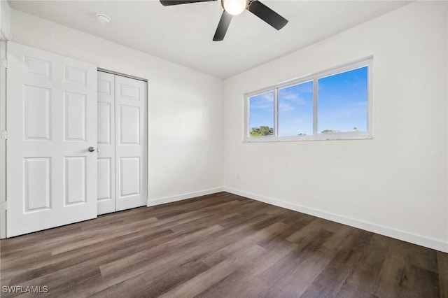 unfurnished bedroom with a closet, ceiling fan, and dark hardwood / wood-style floors