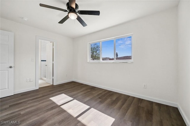 unfurnished bedroom with ceiling fan and dark wood-type flooring