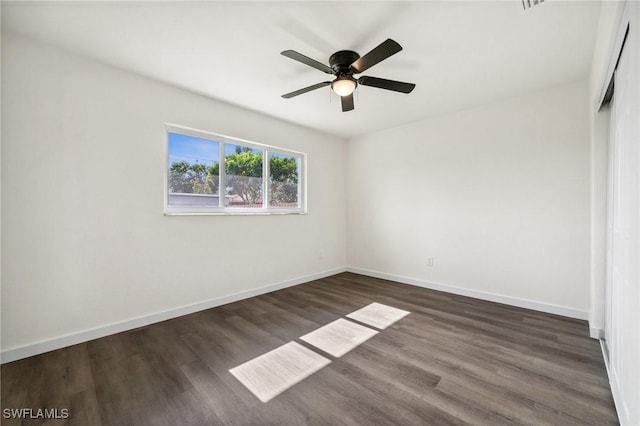 unfurnished bedroom featuring ceiling fan and dark wood-type flooring