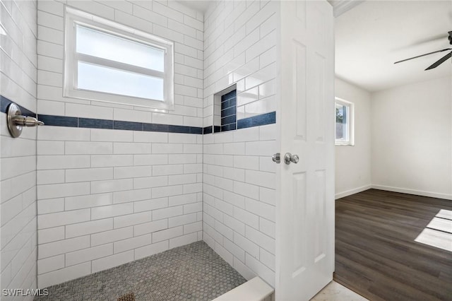 bathroom featuring tiled shower, hardwood / wood-style floors, and ceiling fan