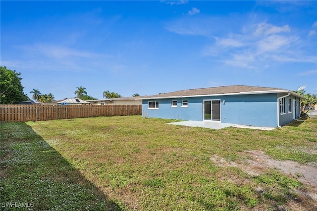 rear view of property with a yard