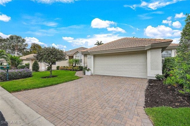 single story home featuring a front yard and a garage