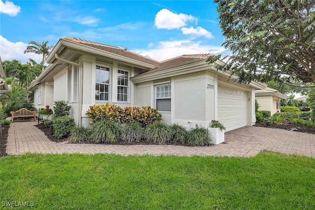 view of side of property featuring a yard and a garage