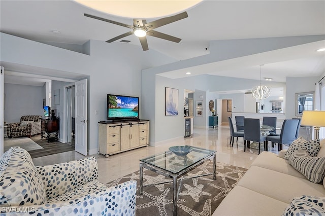 living room featuring ceiling fan with notable chandelier and vaulted ceiling