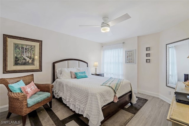 bedroom with ceiling fan and light hardwood / wood-style floors