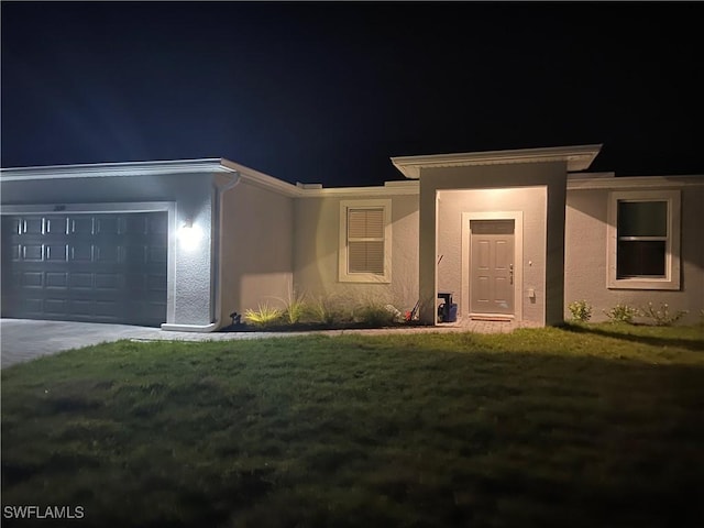 view of front of home featuring a garage and a lawn