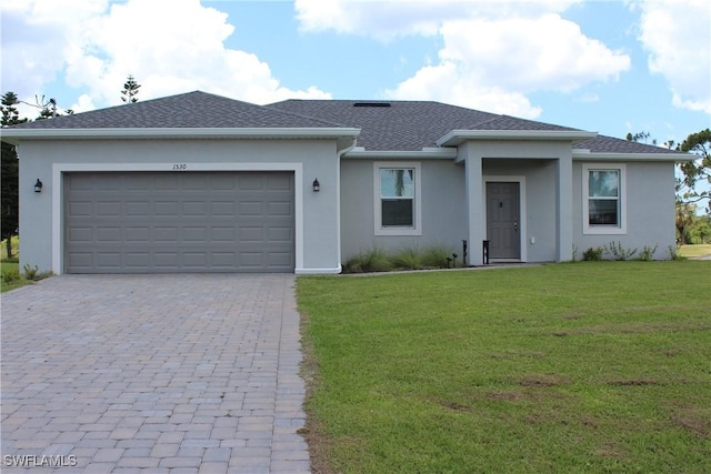 view of front of property featuring a garage and a front lawn