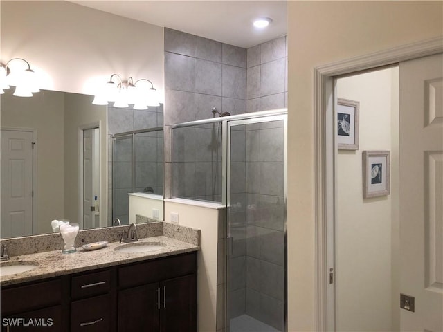 bathroom featuring vanity and an enclosed shower